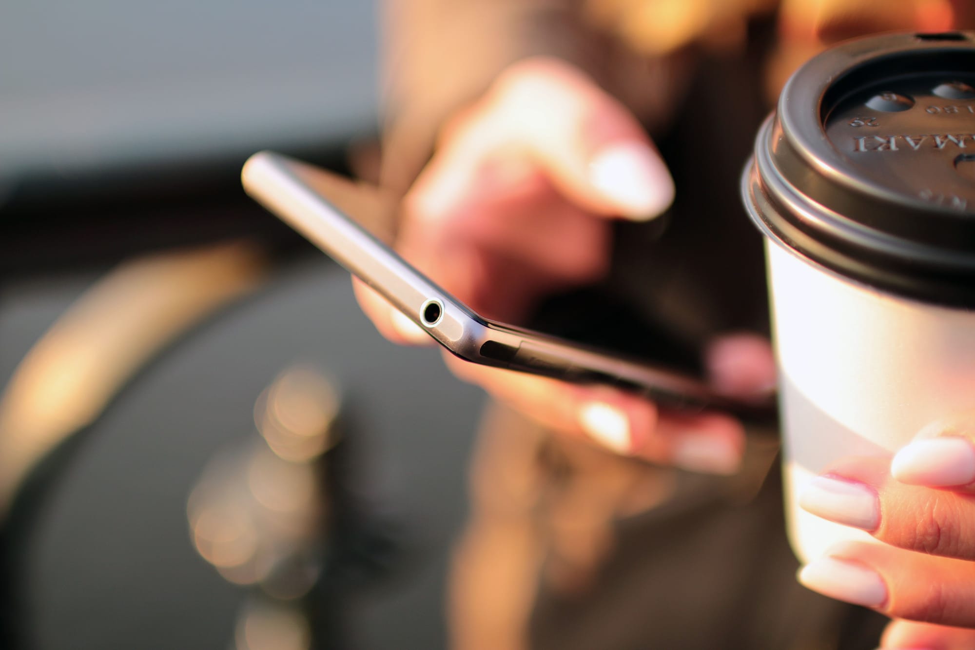 Close-up of hands typing a message on a smartphone